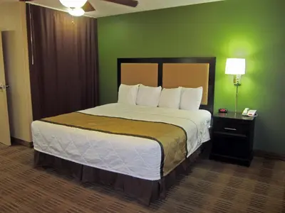 a bedroom with a large bed with a green wall at Extended Stay America Suites - Philadelphia - Plymouth Meeting - East in Plymouth Meeting