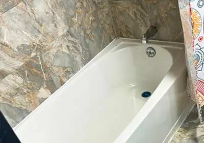 a white bath tub sitting in a bathroom at Philly Inn & Suites in Philadelphia