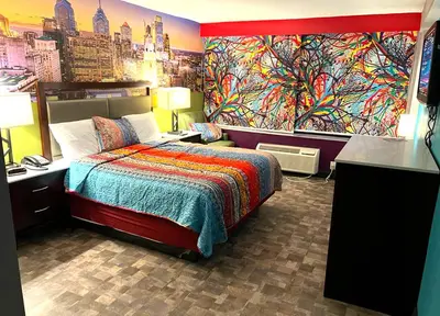 a bedroom with a bed and a painting on the wall at Philly Inn & Suites in Philadelphia