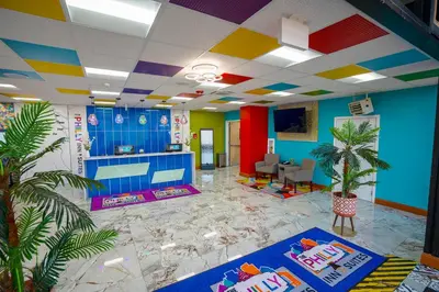 a room with colorful walls and floors with palm trees at Philly Inn & Suites in Philadelphia