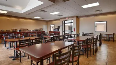 a dining room with wooden tables and chairs at Quality Inn & Suites Williamsport in Williamsport