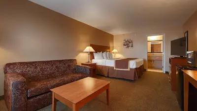a hotel room with a bed and a couch at Quality Inn & Suites Williamsport in Williamsport