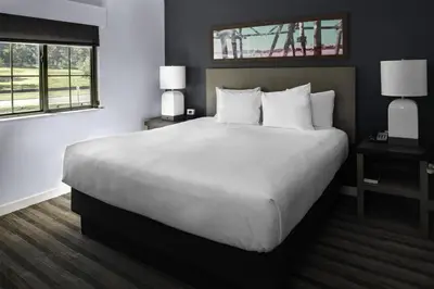 a bedroom with a large bed with white sheets and pillows at Hyatt House Morristown in Morristown