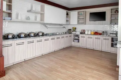 a large kitchen with white cabinets and a wooden floor at Hyatt House Morristown in Morristown