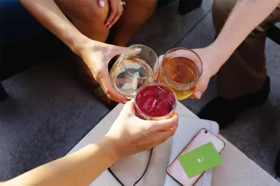 two people holding glasses of wine on a table at Hyatt House Morristown in Morristown