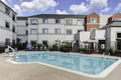 a large swimming pool in front of a building at Hyatt House Parsippany Whippany in Whippany
