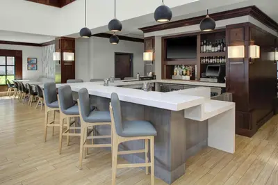 a large kitchen with a large island with bar stools at Hyatt House Parsippany Whippany in Whippany