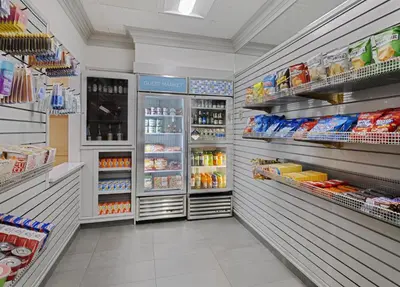 a store aisle with refrigerators and shelves of food at Hyatt House Parsippany Whippany in Whippany