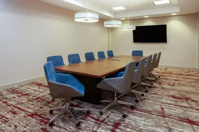 a conference room with a wooden table and chairs at Hilton Garden Inn Valley Forge/Oaks in Oaks