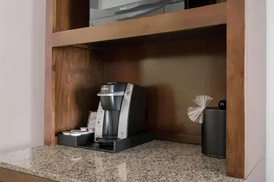 a kitchen with a coffee maker in a shelf at Hilton Garden Inn Valley Forge/Oaks in Oaks