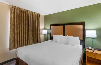 a large bed in a hotel room with two lamps at Extended Stay America Suites - Philadelphia - Horsham - Dresher Rd in Horsham