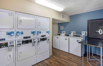 a row of white washing machines in a room at Extended Stay America Suites - Philadelphia - Horsham - Dresher Rd in Horsham
