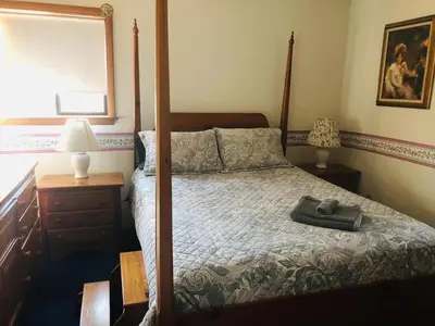 a bedroom with a bed with a wooden frame at My Little Flagship Cabin in East Stroudsburg