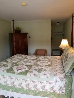 a bedroom with a bed with a quilt on it at Hawk Mountain Bed & Breakfast in Kempton