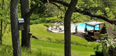 a garden with a swimming pool and a gazebo at Hawk Mountain Bed & Breakfast in Kempton
