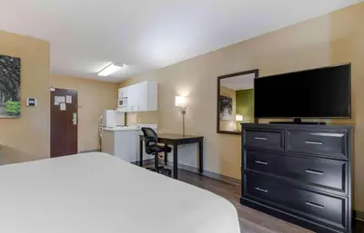 a hotel room with a bed and a flat screen tv at Extended Stay America Suites - Secaucus - Meadowlands in Secaucus