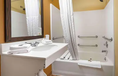 a white bathroom with a sink and a shower at Extended Stay America Suites - Secaucus - Meadowlands in Secaucus