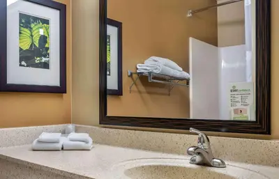 a bathroom with a sink with a mirror and towels at Extended Stay America Suites - Secaucus - Meadowlands in Secaucus