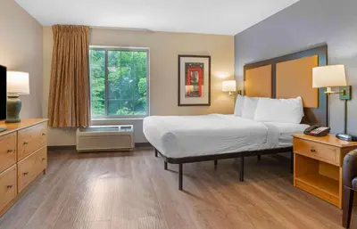 a hotel room with a bed and a window at Extended Stay America Suites - Hanover - Parsippany in Whippany