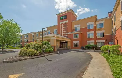 an office building with a clock on top of it at Extended Stay America Suites - Hanover - Parsippany in Whippany