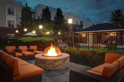 a fire pit with couches and chairs in a courtyard at Hyatt House Branchburg - Bridgewater in Branchburg Park