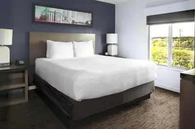 a hotel room with a large bed and a window at Hyatt House Branchburg - Bridgewater in Branchburg Park