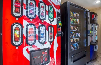 a soda machine in a store next to a vending machine at Extended Stay America Suites - Newark - Woodbridge in Woodbridge