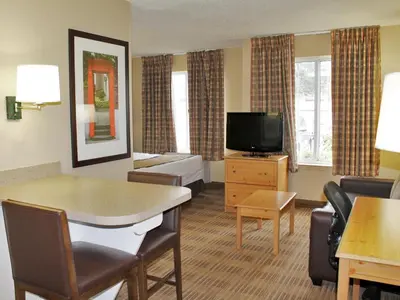 a hotel room with a living area with a television at Extended Stay America Suites - Newark - Woodbridge in Woodbridge