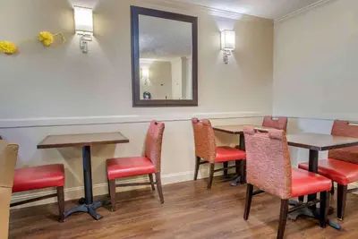 a waiting room with tables and chairs and a mirror at Extended Stay America Suites - Philadelphia - King of Prussia in King of Prussia