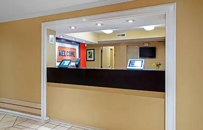 a hotel lobby with a reception counter with a mirror at Extended Stay America Suites - Newark - Christiana - Wilmington in Rutherford