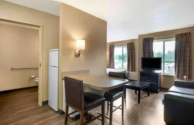 a living room with a table and chairs in a room at Extended Stay America Suites - Newark - Christiana - Wilmington in Rutherford