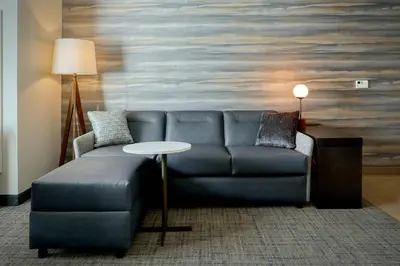 a living room with a blue couch and a table at Residence Inn by Marriott Harrisburg North in Harrisburg