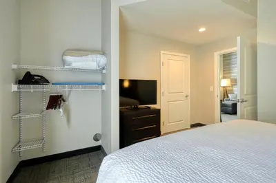 a bedroom with a bed and a tv and a room at Residence Inn by Marriott Harrisburg North in Harrisburg