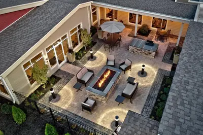 an aerial view of a patio with chairs and an umbrella at Residence Inn by Marriott Harrisburg North in Harrisburg