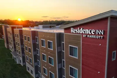 a building with a residence inn sign on it at sunset at Residence Inn by Marriott Harrisburg North in Harrisburg