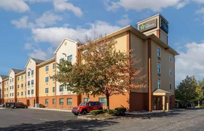 a hotel building with a car parked in a parking lot at Extended Stay America Suites - Philadelphia - Airport - Tinicum Blvd in Philadelphia