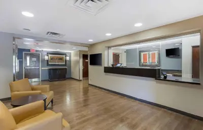 a lobby with a waiting room with chairs and a counter at Extended Stay America Suites - Philadelphia - Airport - Tinicum Blvd in Philadelphia