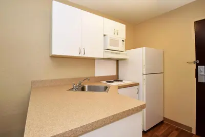 a small kitchen with a sink and a white refrigerator at Extended Stay America Suites - Philadelphia - Airport - Tinicum Blvd in Philadelphia