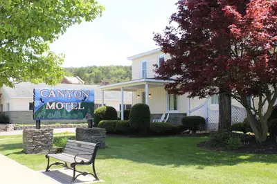 a sign for a motel in front of a house at Canyon Motel in Wellsboro