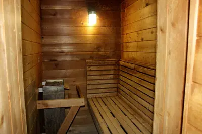 a small wooden sauna with a bench in it at Canyon Motel in Wellsboro