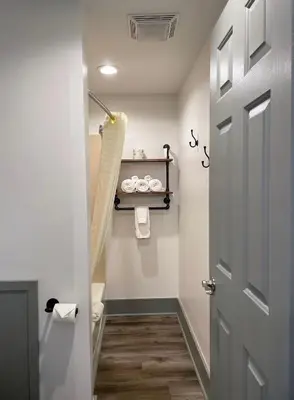 a bathroom with a toilet and a door at Canyon Motel in Wellsboro