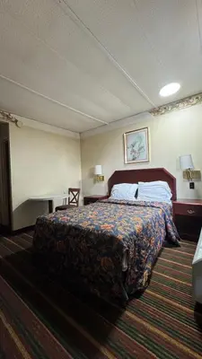 a hotel room with a bed and a desk at Rodeway Inn Dunmore in Dunmore