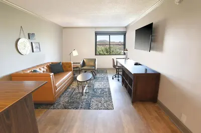 a living room with a couch and a desk at Four Points by Sheraton York in York