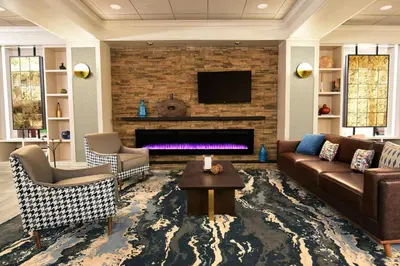 a living room with a couch and a fireplace at Four Points by Sheraton York in York