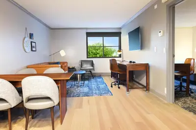 a living room with a table and a desk at Four Points by Sheraton York in York
