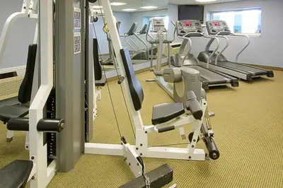 a gym with rows of treadmills and ellipticals at Four Points by Sheraton York in York