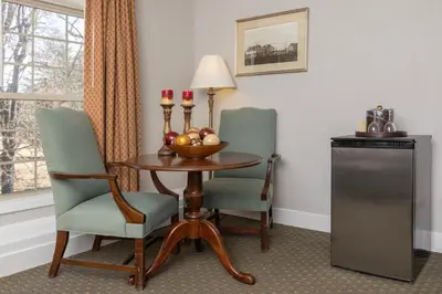 a hotel room with a table and two chairs at Brandywine River Hotel in Chadds Ford
