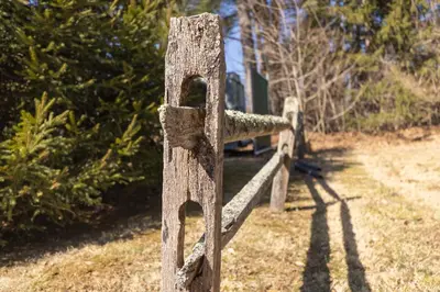 an old wooden fence post in a field at Brandywine River Hotel in Chadds Ford