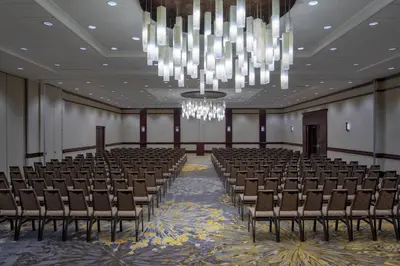 an empty banquet hall with chairs and a chandelier at The Westin Mount Laurel in Mount Laurel
