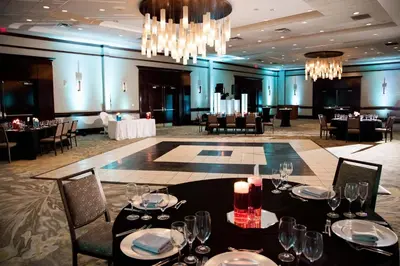 a dining room with tables and chairs and a chandelier at The Westin Mount Laurel in Mount Laurel